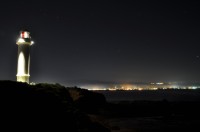 Lighthouse and Coastline at Night