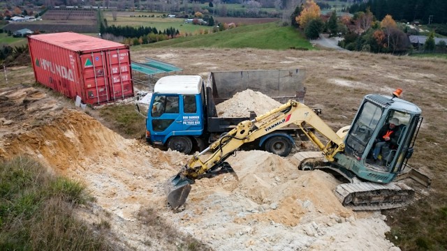 Cutting the hill with a 4-ton digger