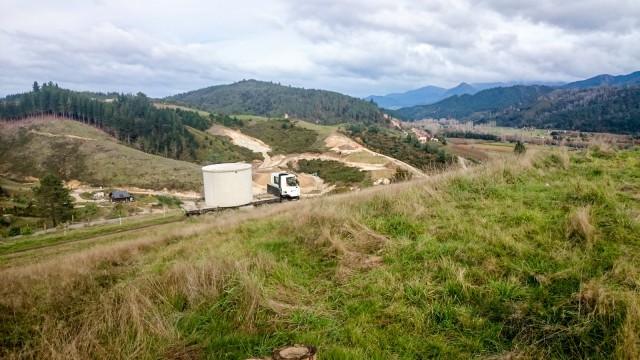 The first tank comes up the hill