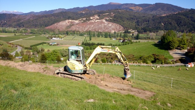 A digger, preparing the terraces for our wastewater disposal area