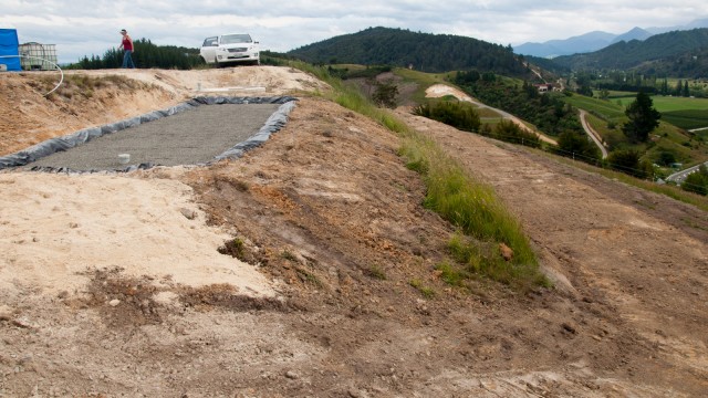 The finished system. Tank and wetland on top, irrigation pipes buried on the terrace below