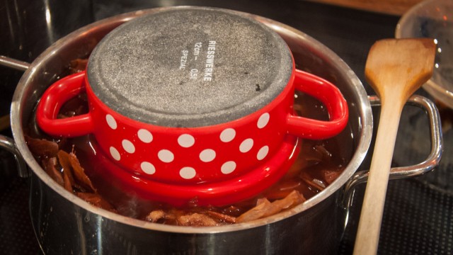 Put in a pot with heaps of onionskin and cook for some time, then let it sit over night.