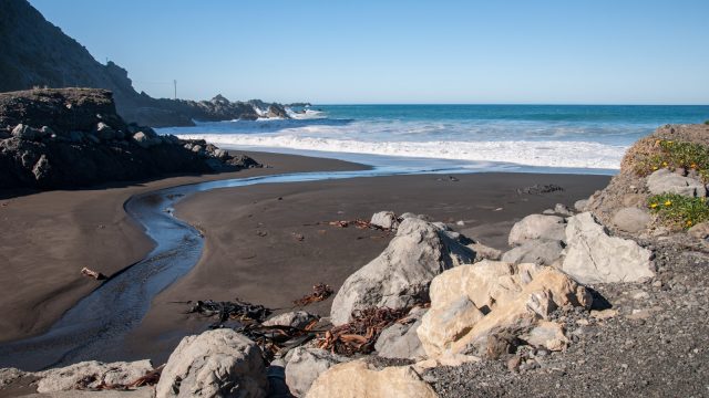 Black sand and big waves.