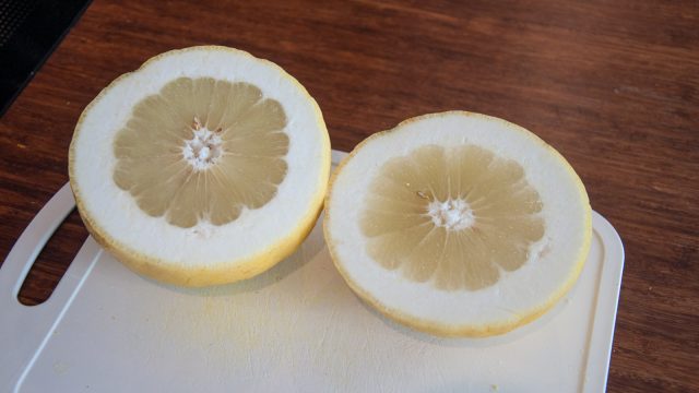 It has the shape of a grapefruit, a thick skin of a pomelo and tastes like a giant lemon. Any ideas what it is?